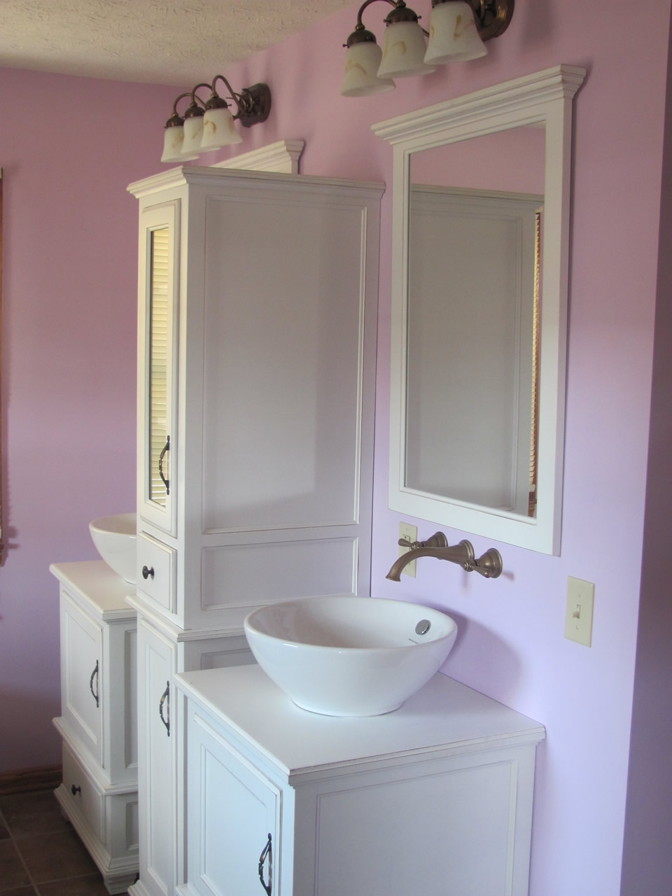 Custom cabinet and dual vanities in renovated bathroom